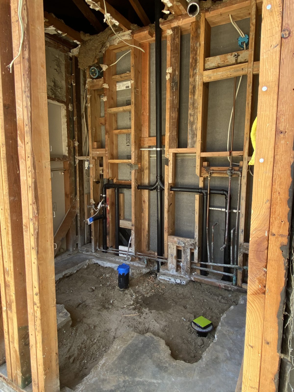 New ABS drain and water lines roughed into open framing during a whole-house repipe